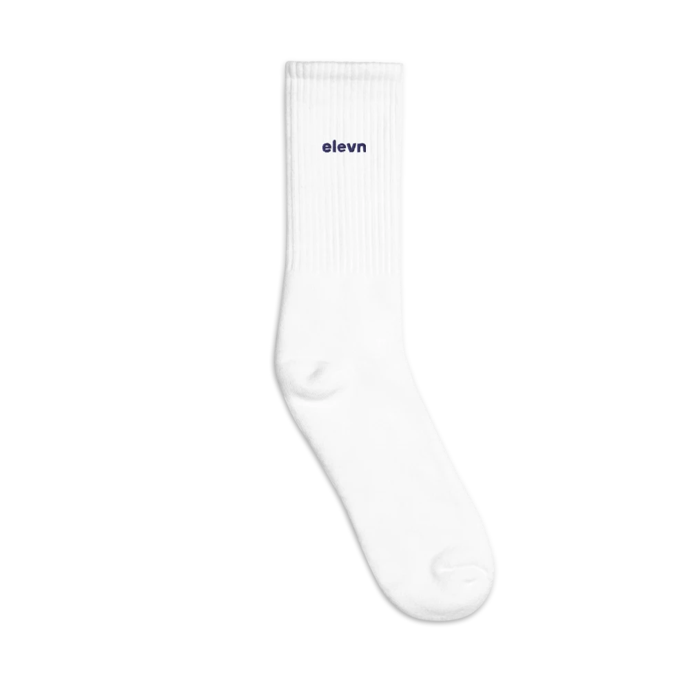 Athletic crew socks with a small elevn logo on the cuff